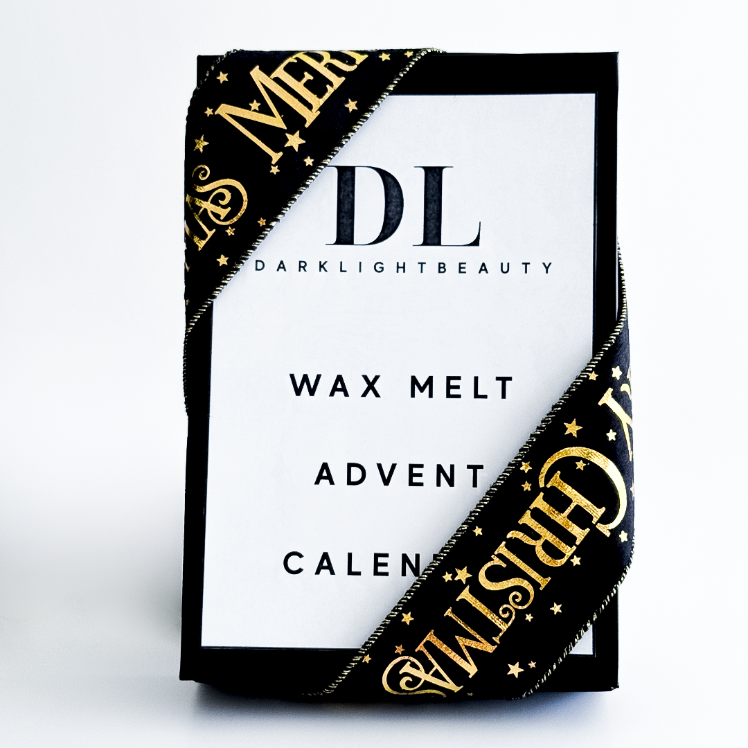Darklight Beauty wax melt advent calendar packaging with gold and black design.