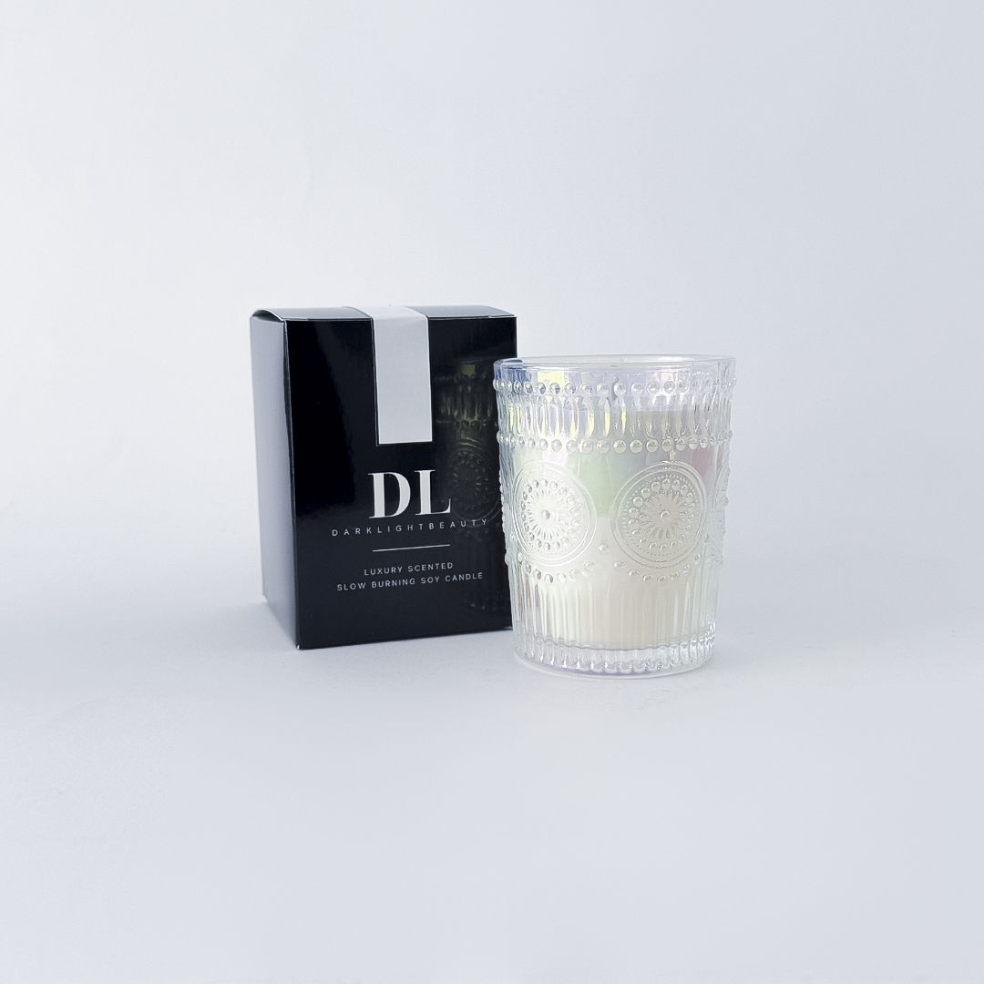 Candle with decorative packaging on a white background
