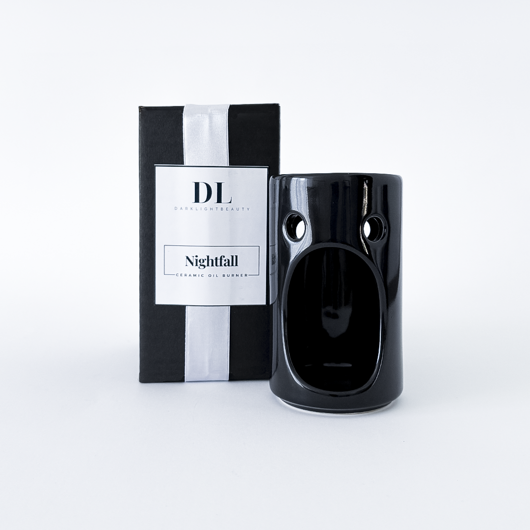 Black ceramic oil burner with packaging labeled 'DL Nightfall' on a white background