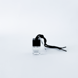 Small clear container with a black lid on a white background