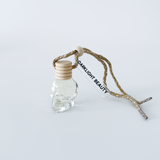 Small glass bottle with wooden cap and rope on a white background, featuring 'Darklight Beauty' branding.