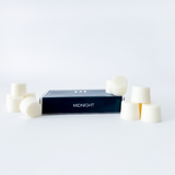 Box labeled 'Midnight' with white cylindrical objects on a light gray background