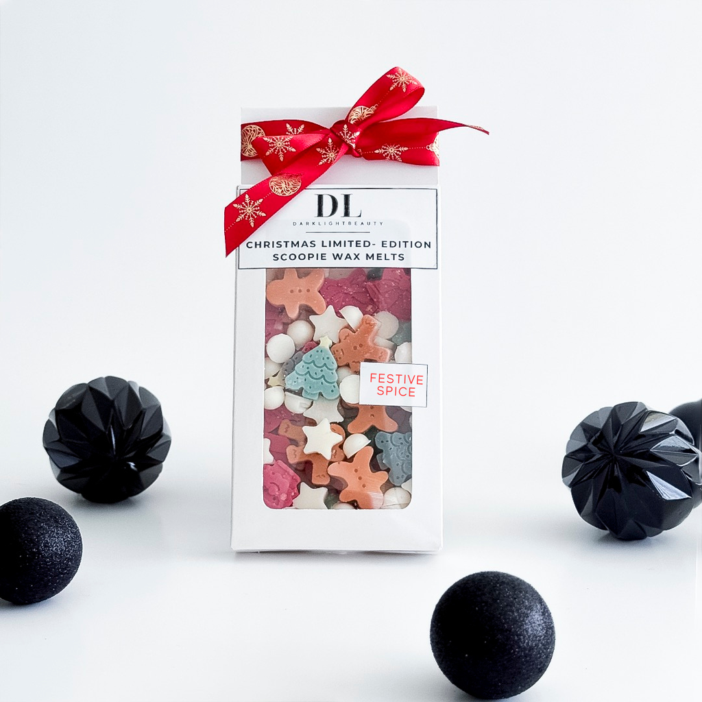 Packaged Christmas wax melts with a red ribbon on a white background