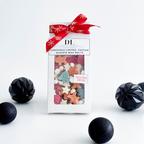 Packaged Christmas wax melts with a red ribbon on a white background