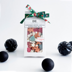 Packaged Christmas limited edition scoopie wax melts with decorative ribbon on a white background