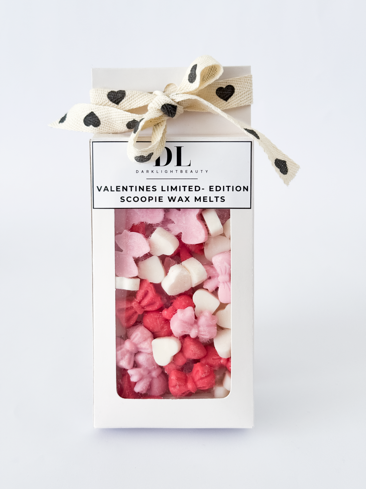 Valentine's Day themed scoopie wax melts in a box with a decorative bow on a white background
