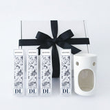 Set of mystery wax melts with Darklight Beauty branding and a white ceramic diffuser on a white background