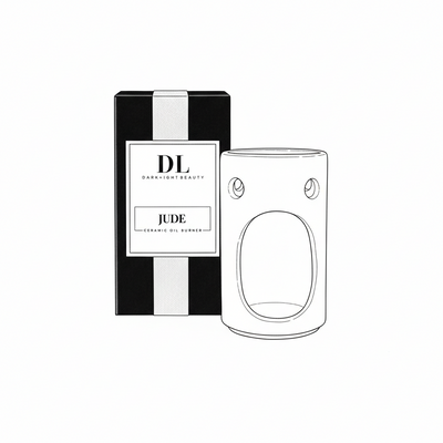 Ceramic oil burner with packaging labeled 'JUDE' by 'DL Darklight Beauty' on a white background.
