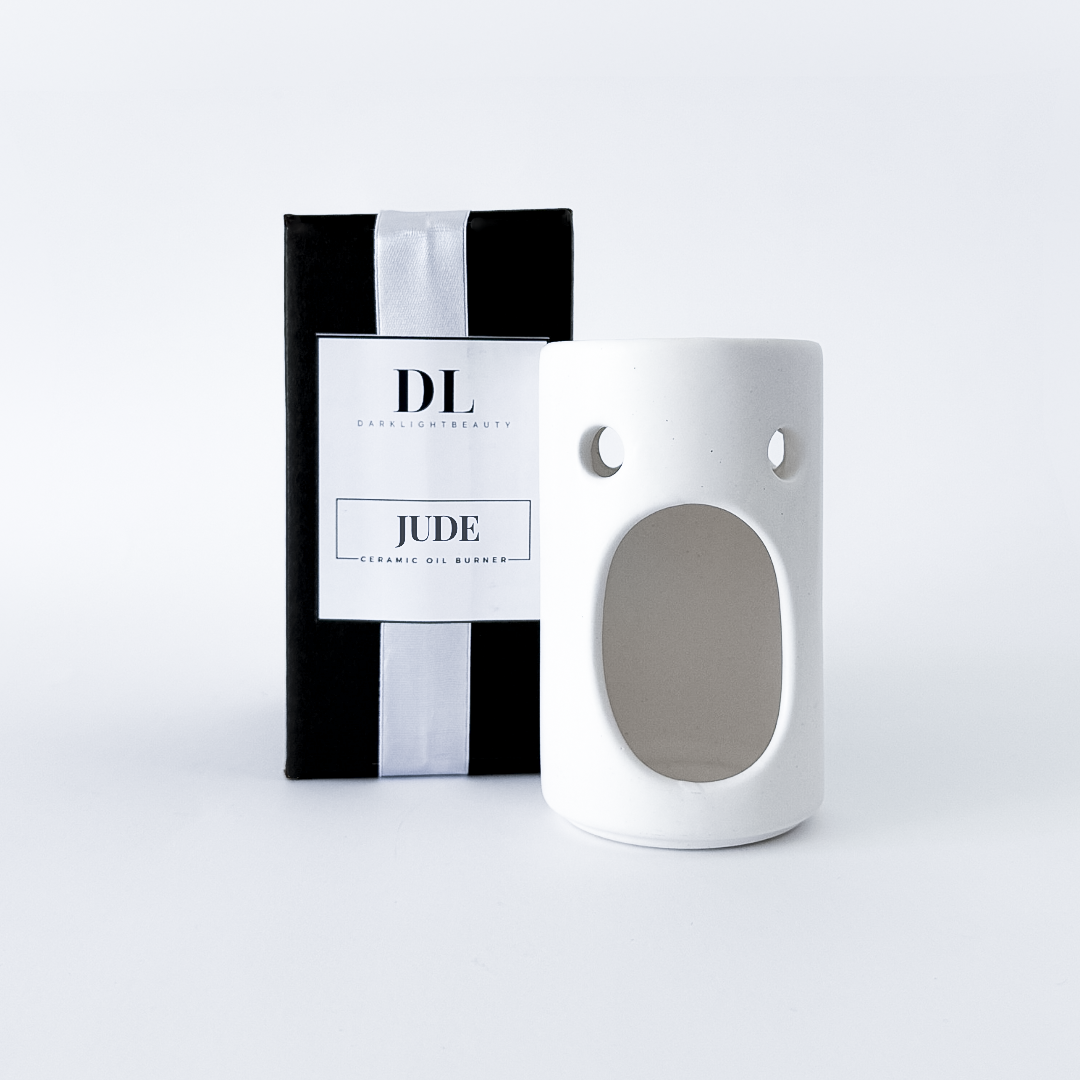 White ceramic oil burner with black and white packaging labeled 'DL Jude' on a white background